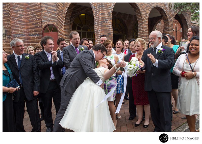 Sydney-Catholic-Church-Wedding-Bride-and-Groom-Kiss-outside-of-church-photo-by-Biblino-Images
