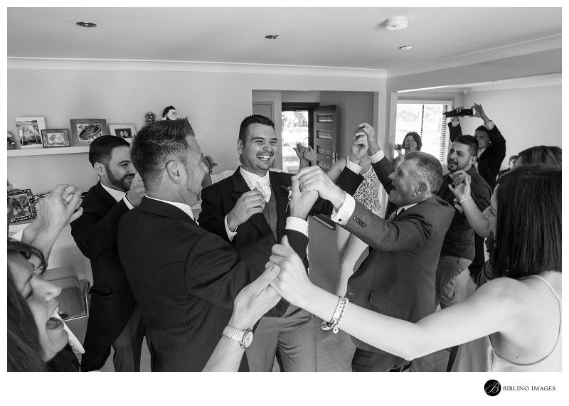 Groom-dances-with-family-and-guests-at-the-house