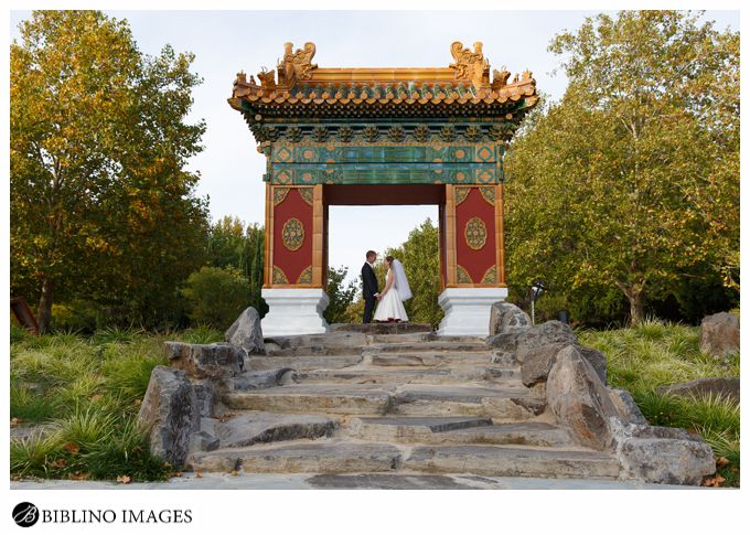 Bride groom pose at the gate of Canberra Beijing garden