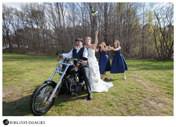 bride throws bouquet while on a harley davidson